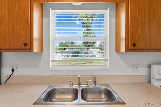 kitchen featuring washer / dryer and sink