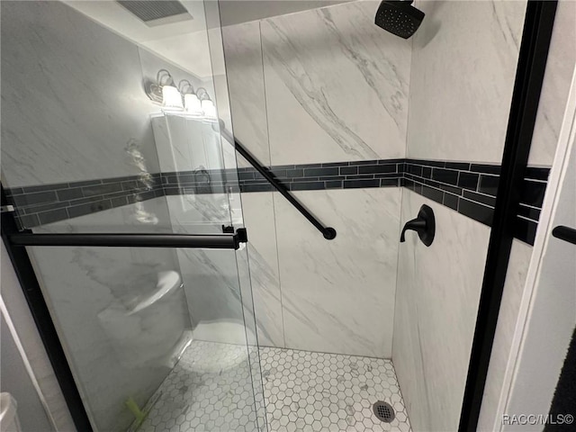 bathroom with a shower with door