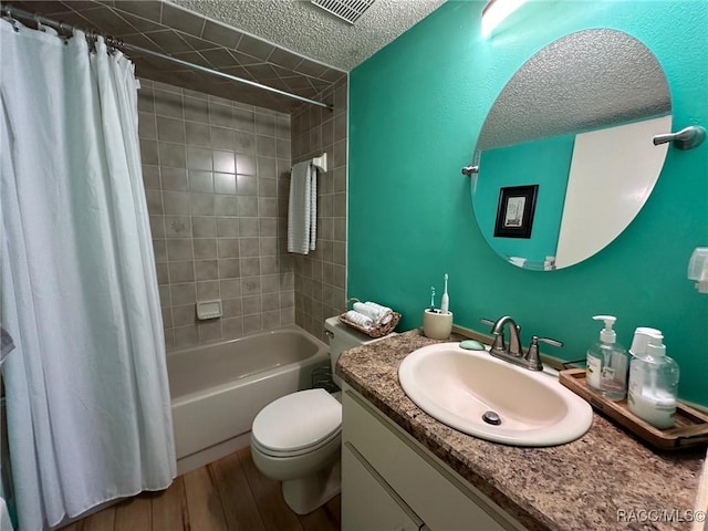 full bathroom with toilet, a textured ceiling, vanity, shower / bath combo, and hardwood / wood-style flooring