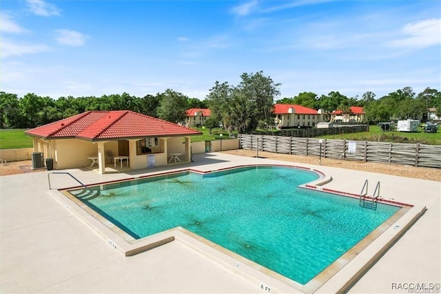 view of swimming pool featuring central AC and a patio area