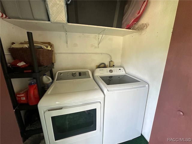 washroom with washing machine and clothes dryer