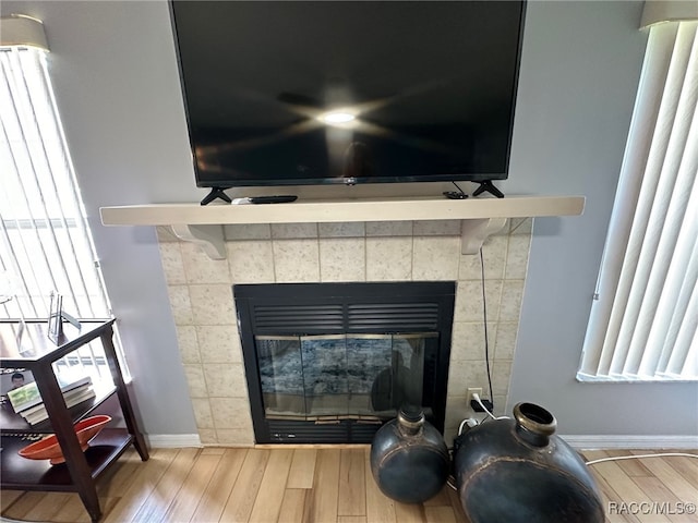 interior details with wood-type flooring and a fireplace