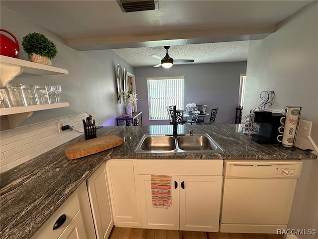 kitchen featuring sink, wood-type flooring, white dishwasher, ceiling fan, and white cabinets