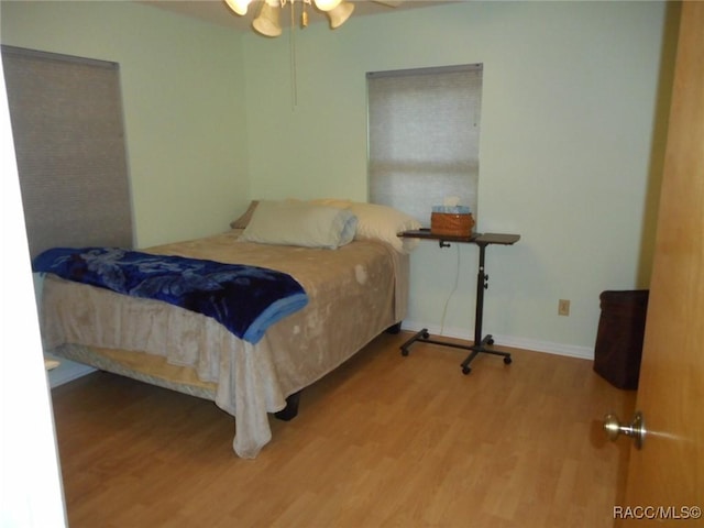 bedroom with hardwood / wood-style floors and ceiling fan