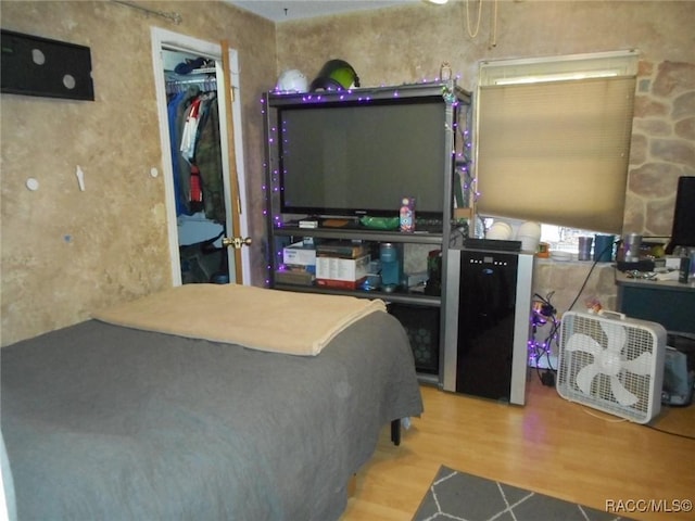 bedroom with hardwood / wood-style flooring and a closet