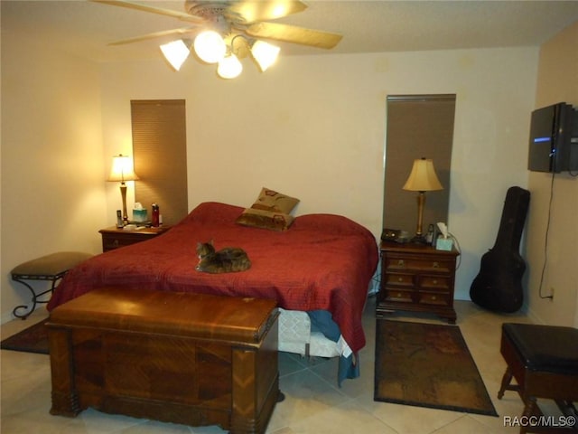 tiled bedroom with ceiling fan