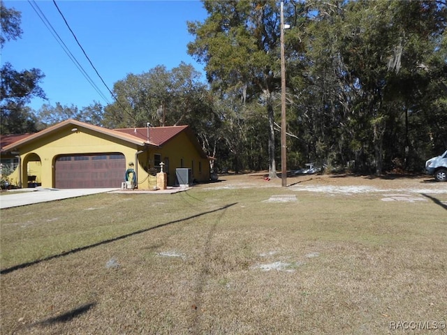 exterior space with central air condition unit and a garage