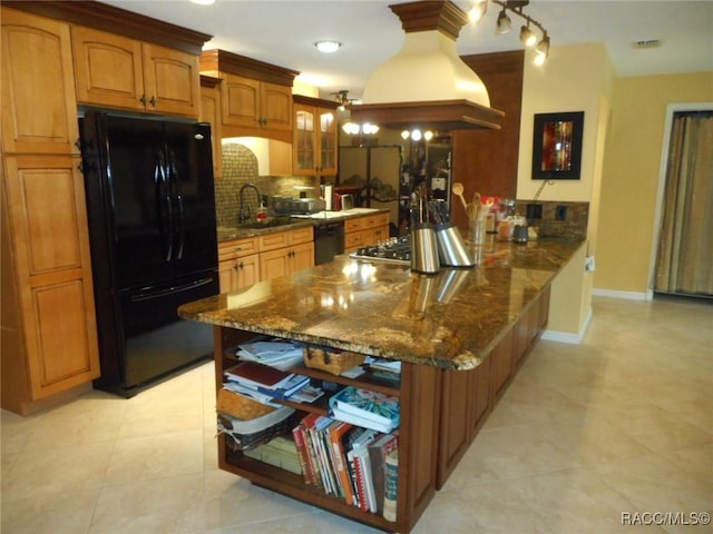 kitchen with kitchen peninsula, backsplash, dark stone counters, custom exhaust hood, and black appliances