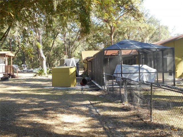 view of yard with glass enclosure