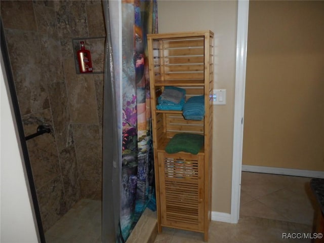 bathroom featuring tile patterned floors and curtained shower