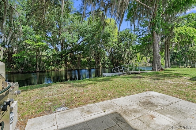 view of yard featuring a patio and a water view