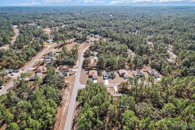 drone / aerial view with a residential view and a forest view