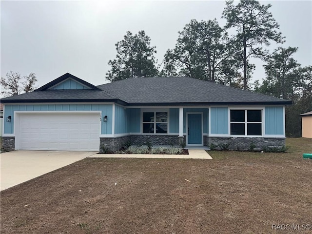 view of front of property with a garage, concrete driveway, brick siding, and board and batten siding