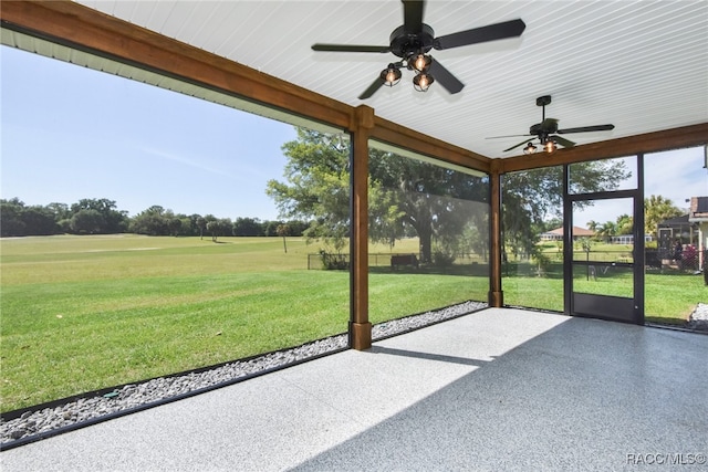 unfurnished sunroom with ceiling fan