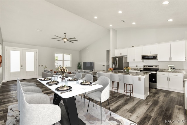 dining room featuring ceiling fan, french doors, high vaulted ceiling, and dark wood-type flooring