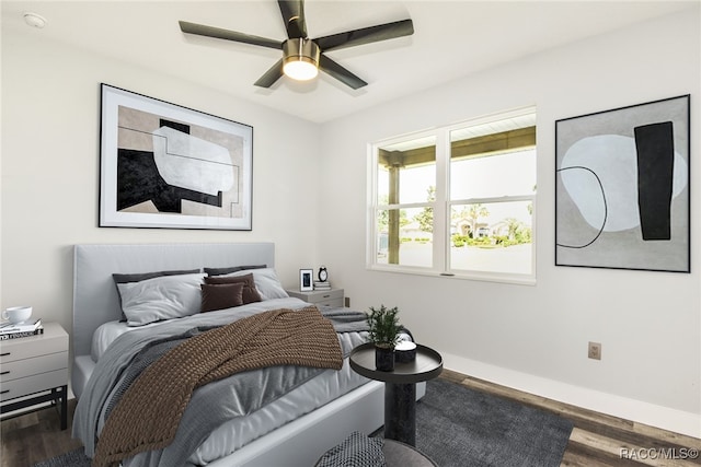 bedroom featuring dark hardwood / wood-style flooring and ceiling fan