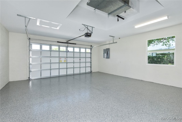 garage featuring electric panel and a garage door opener