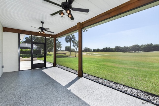 unfurnished sunroom with ceiling fan