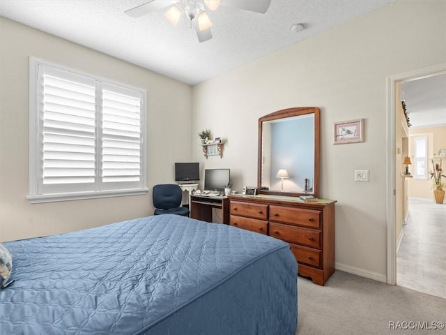 18514 Hidden Pines Way, Hudson, FL 34667 - bedroom featuring light carpet, a ceiling fan, a textured ceiling, and baseboards