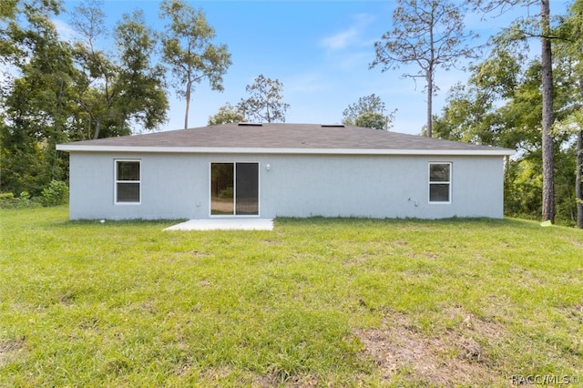 rear view of property with a yard and a patio