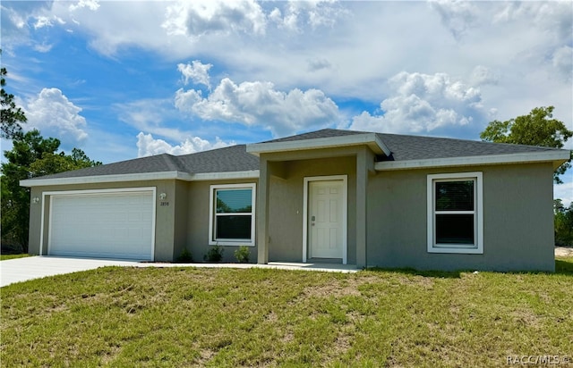 ranch-style house featuring a front yard and a garage