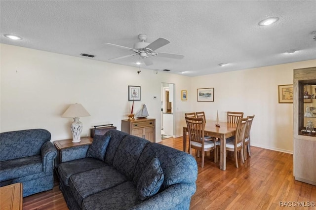 839 N Foxrun Ter, Inverness, FL 34453 - living room featuring a textured ceiling, a ceiling fan, and wood finished floors