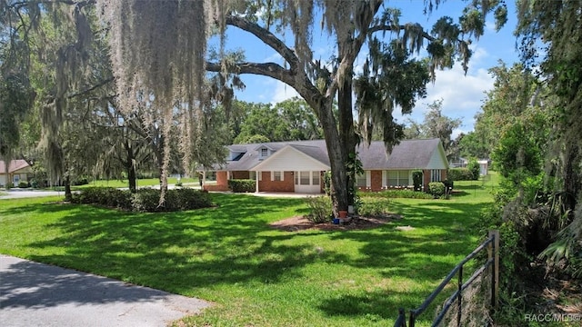 839 N Foxrun Ter, Inverness, FL 34453 - single story home with a front lawn and brick siding