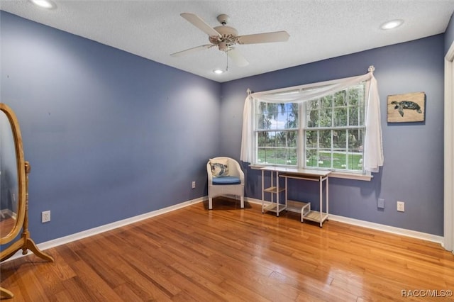 839 N Foxrun Ter, Inverness, FL 34453 - living area featuring wood finished floors, ceiling fan, and a textured ceiling