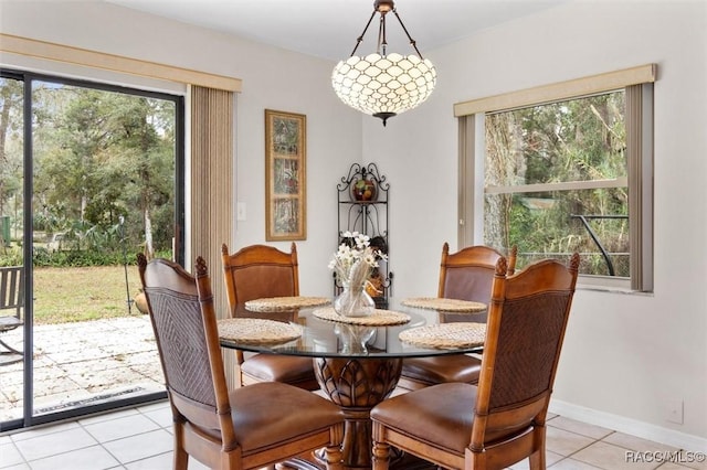 dining area with light tile patterned floors and baseboards