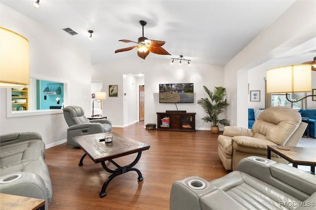 living room featuring ceiling fan, visible vents, vaulted ceiling, and wood finished floors