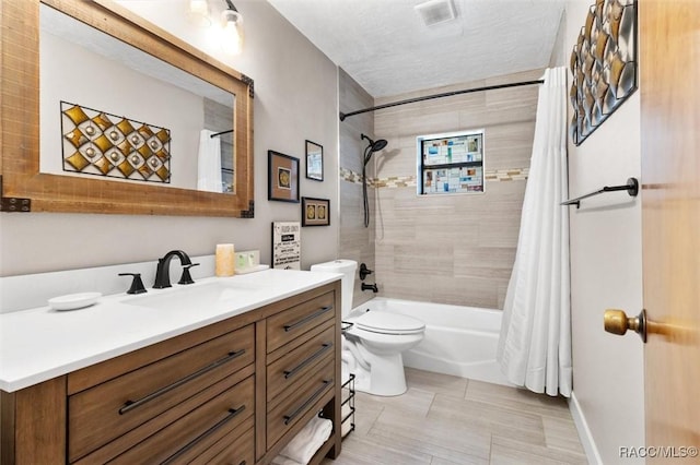 full bathroom featuring visible vents, shower / bathtub combination with curtain, toilet, vanity, and a textured ceiling