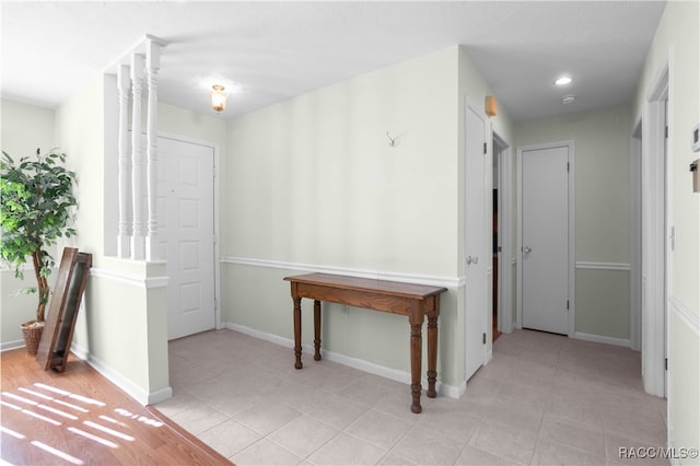 hall featuring light tile patterned floors