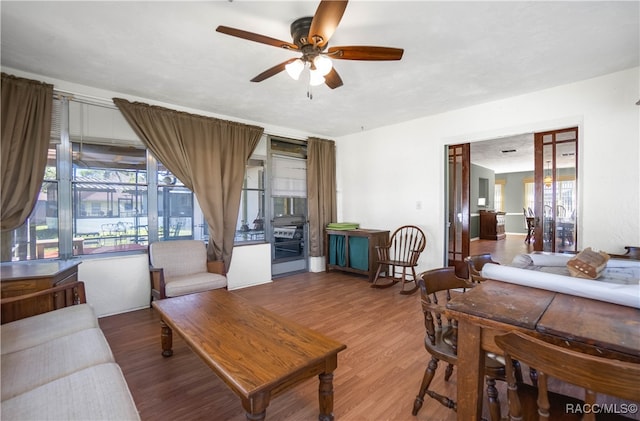 living room featuring hardwood / wood-style floors and ceiling fan