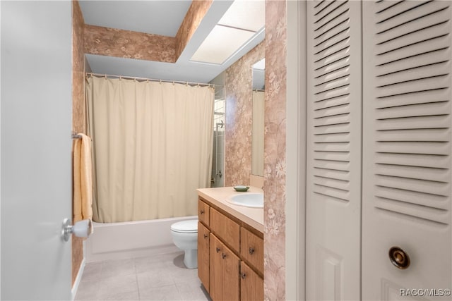 full bathroom with tile patterned flooring, vanity, toilet, and shower / bath combo with shower curtain