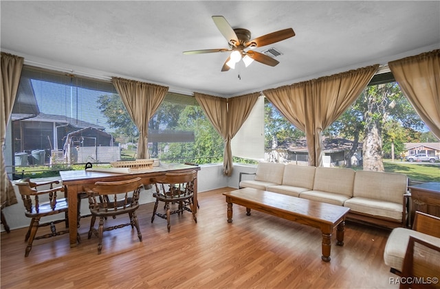 sunroom / solarium featuring ceiling fan