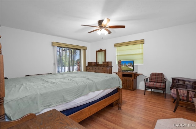 bedroom with hardwood / wood-style floors and ceiling fan