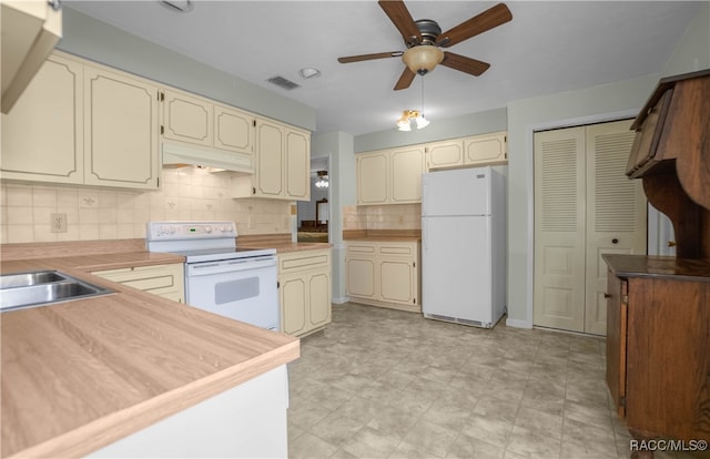 kitchen featuring cream cabinets, white appliances, tasteful backsplash, and ceiling fan