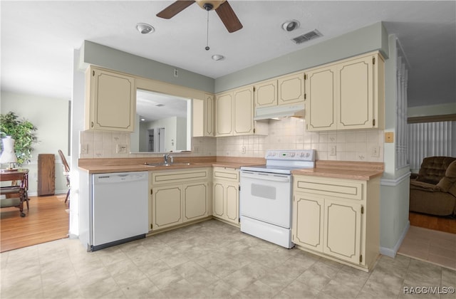 kitchen featuring ceiling fan, decorative backsplash, white appliances, and cream cabinets