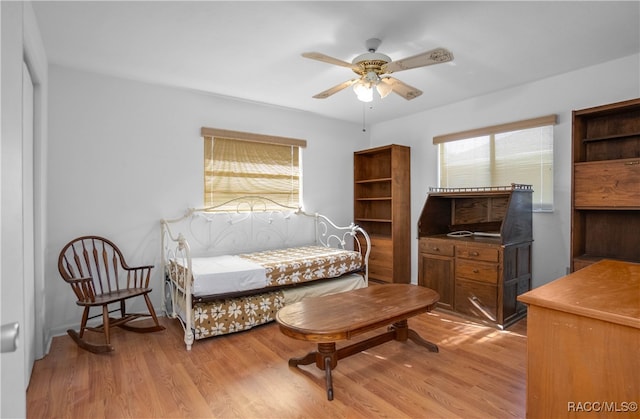 living area featuring ceiling fan and light hardwood / wood-style floors