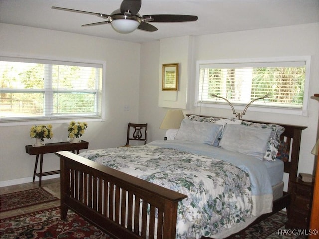 bedroom featuring ceiling fan and multiple windows