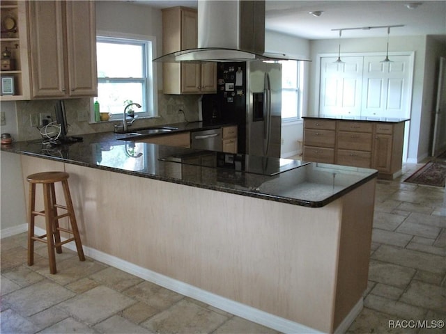 kitchen featuring appliances with stainless steel finishes, sink, backsplash, island exhaust hood, and kitchen peninsula