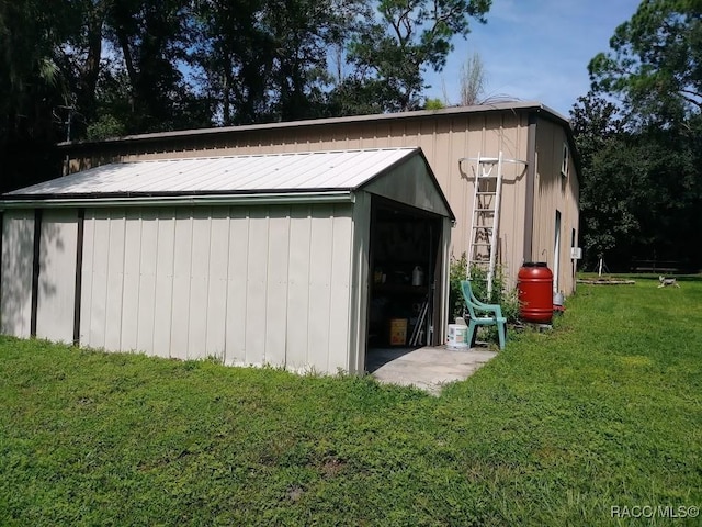 view of outbuilding featuring a lawn