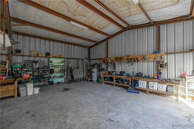 25 64th St, Yankeetown, FL 34498 - garage featuring a workshop area and metal wall