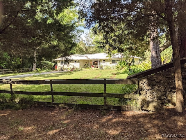 view of gate featuring a yard