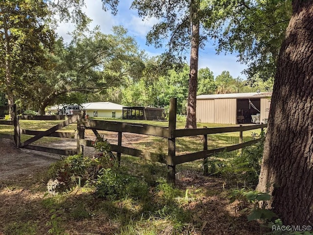 view of gate with an outbuilding