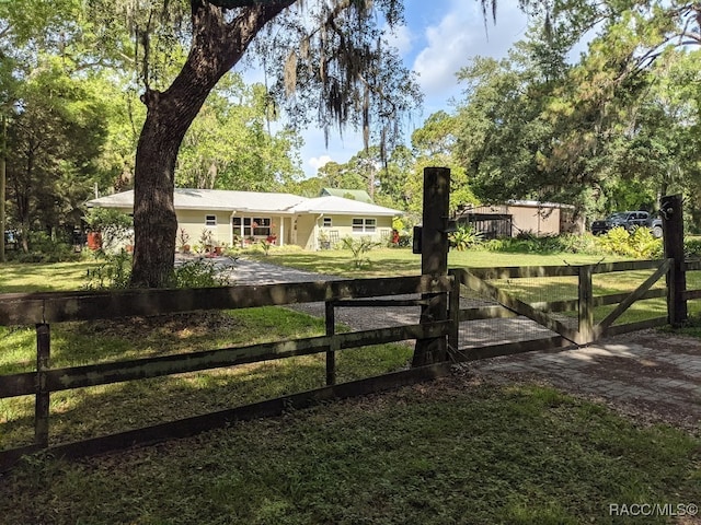 view of gate featuring a lawn