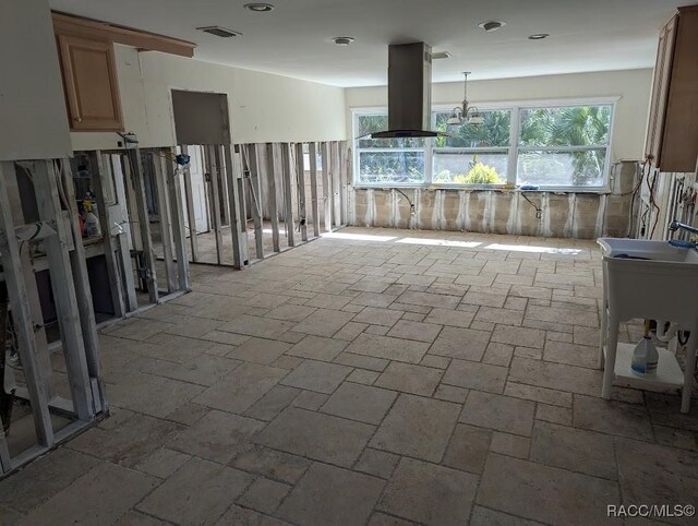 kitchen with island exhaust hood and hanging light fixtures