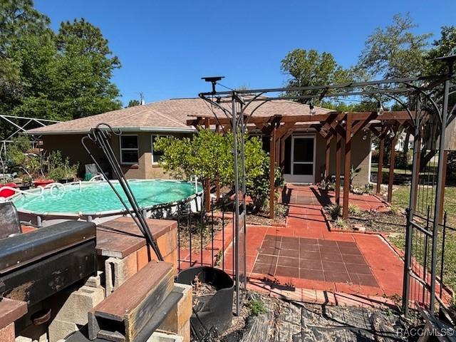 back of house featuring a patio and an outdoor pool
