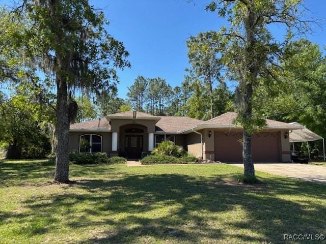 single story home featuring driveway, a front lawn, a garage, and stucco siding