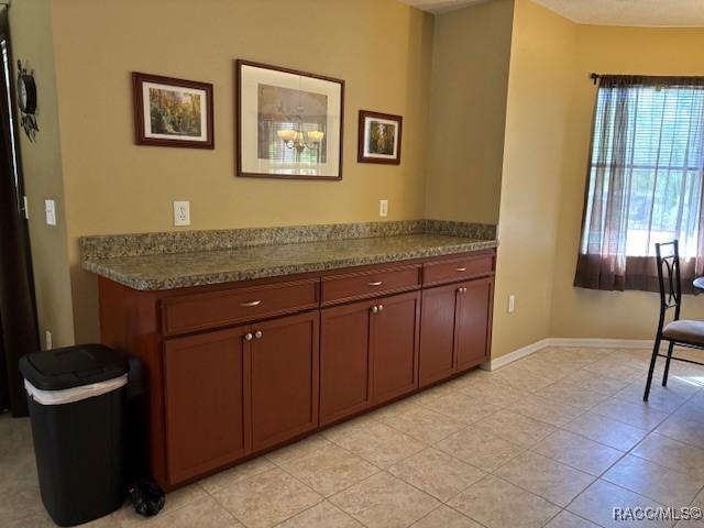 kitchen featuring light tile patterned floors and baseboards
